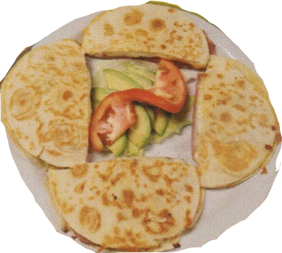 A plate of quesadillas accompanied by colorful vegetables, served at a Mexican restaurant.